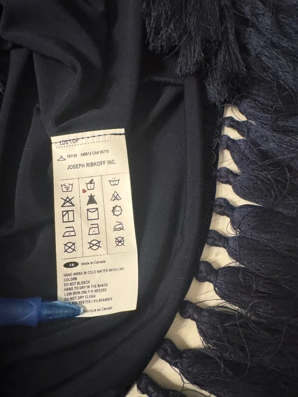 Joseph Ribkoff silky top size M with distinctive fringe along cuffs and hem